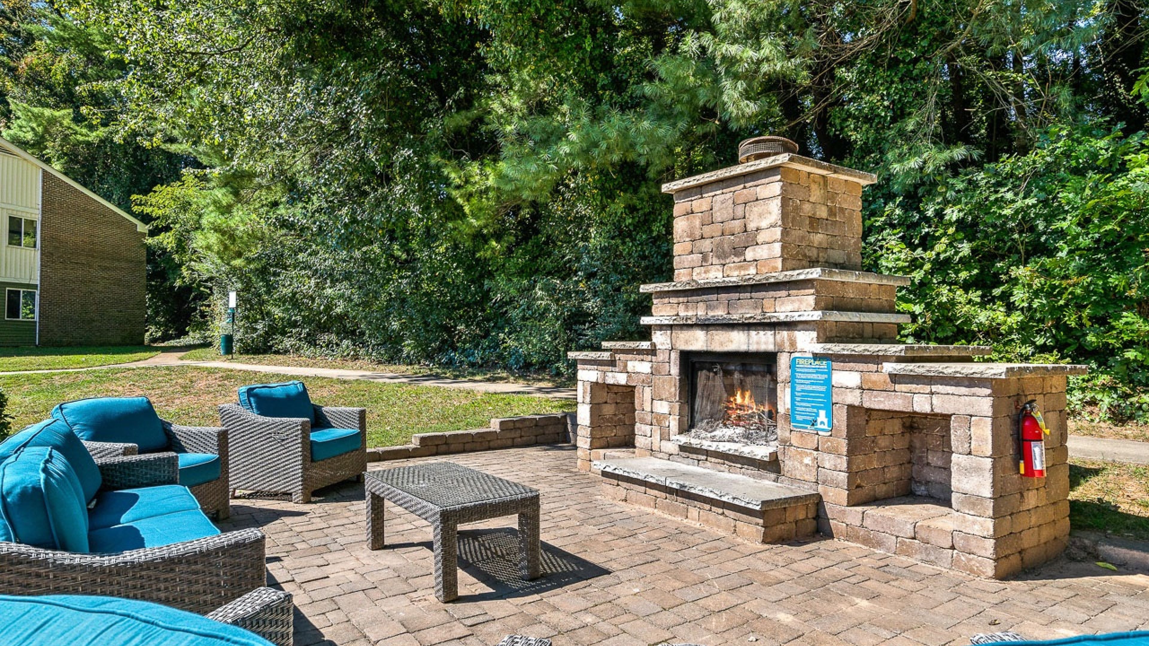 Hawthorne at Bear Creek outdoor patio with stone fire place and surrounding lounge seating