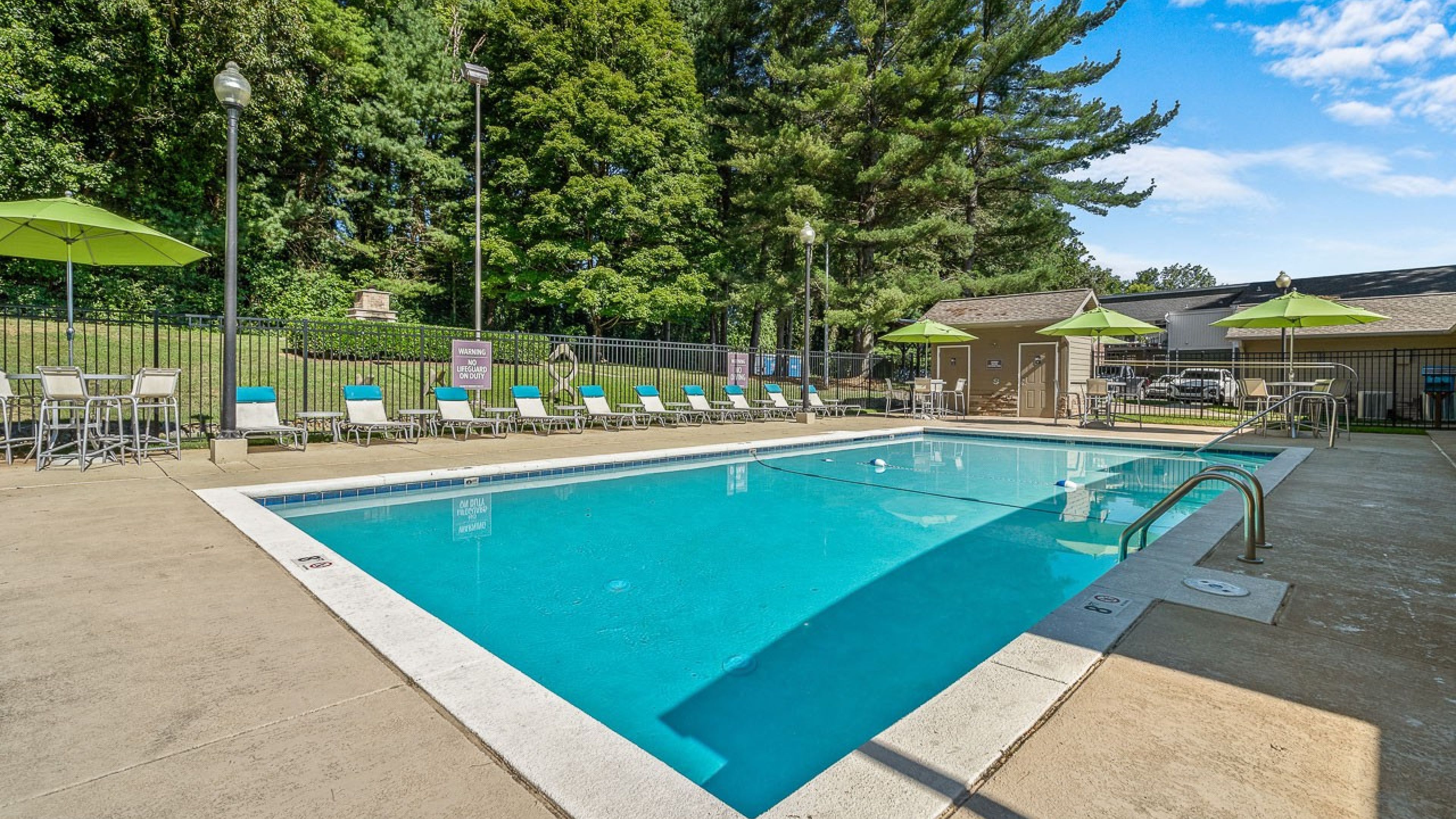 Hawthorne at Bear Creek community exterior pool with lounge seating and trees