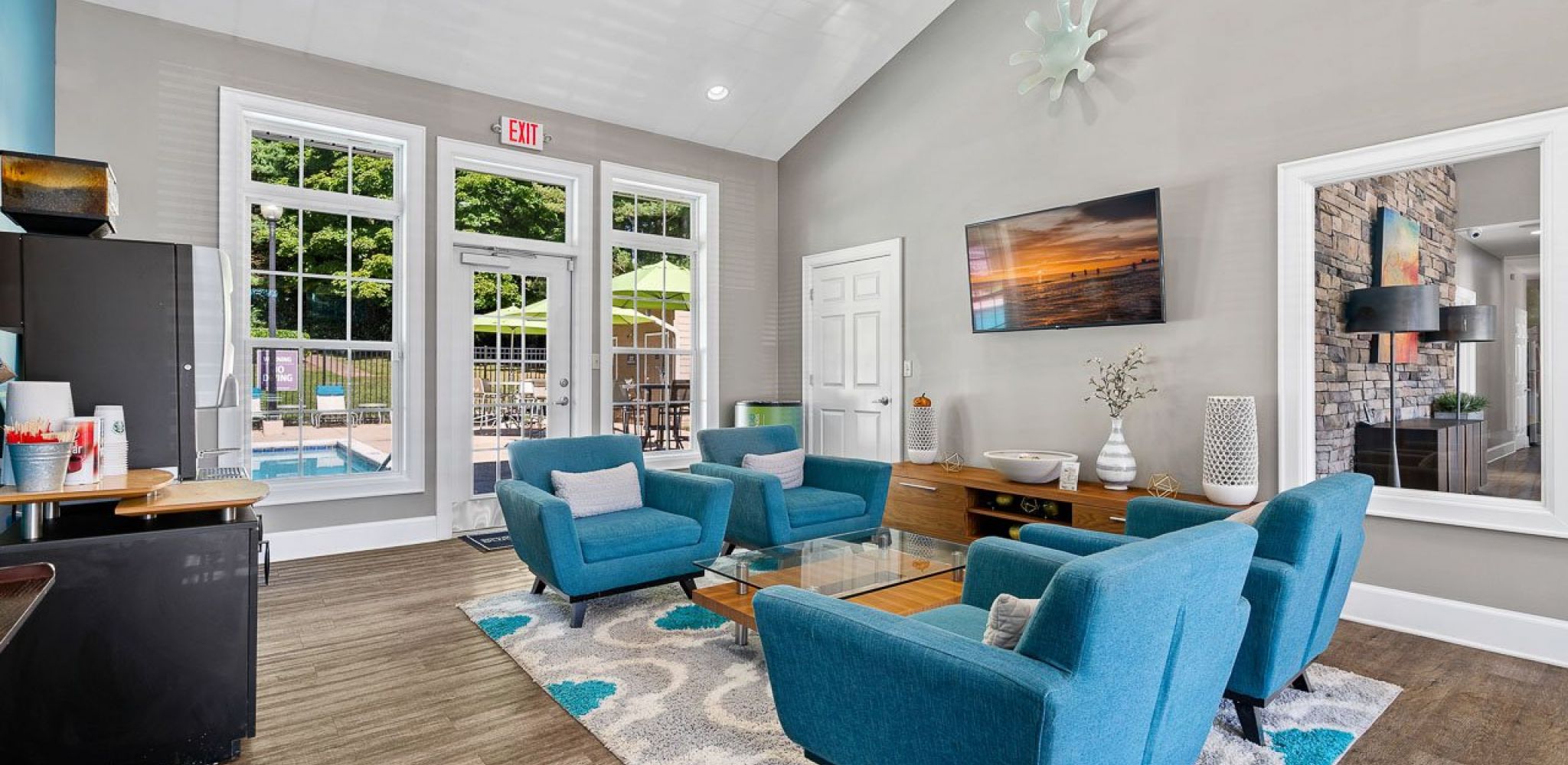 Hawthorne at Bear Creek resident amenity area with coffee area, seating, and large screen TV